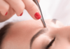 Eyebrow shaping with tweezers and wax