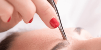Eyebrow shaping with tweezers and wax